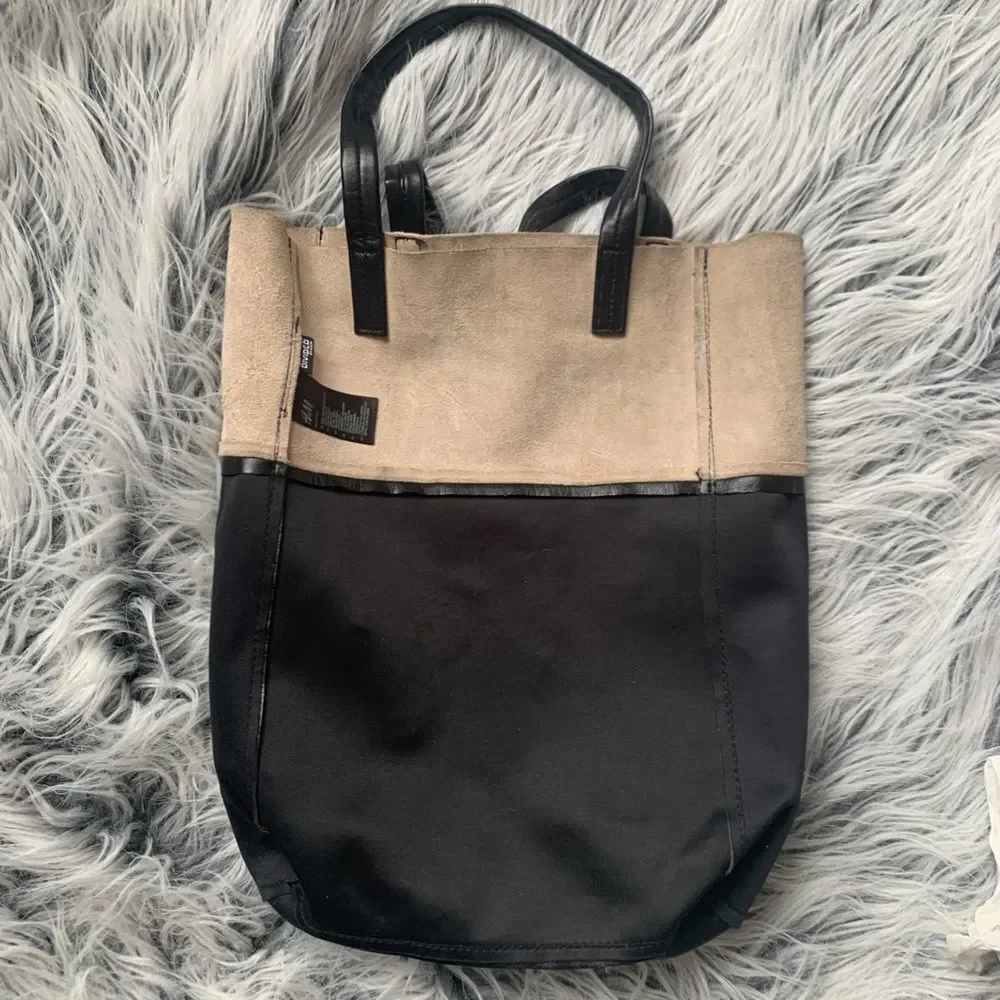 Soft, color-block Shopper Tote with concealed magnetic fastener at top. Unlined.
